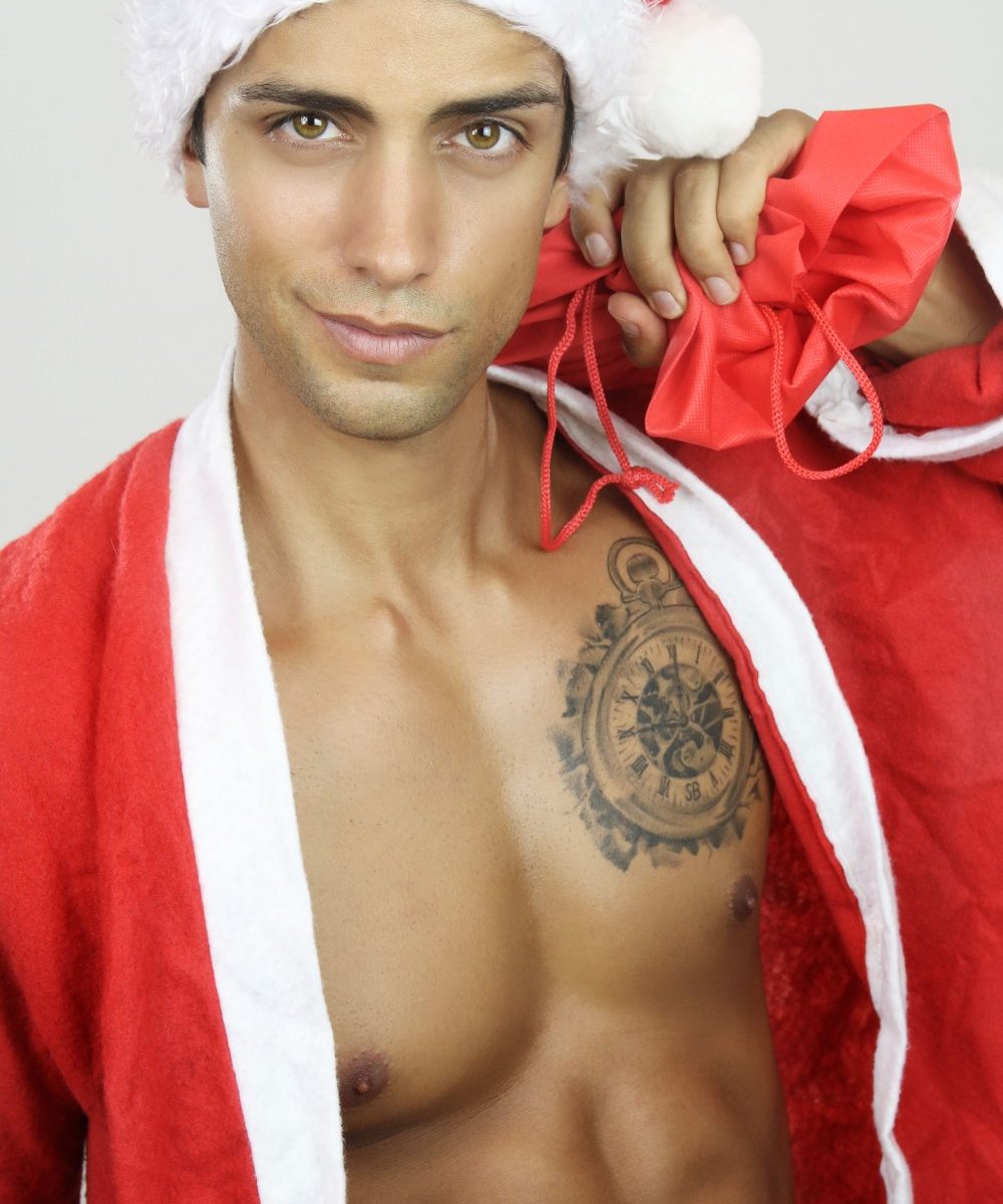 sexy guy with a tattoo in a santa outfit