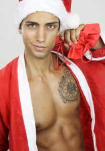 sexy guy with a tattoo in a santa outfit